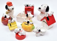 10 Ceramic Peanuts Snoopy Figures. Various types including - Snoopy and Woodstock laying on a lemon,