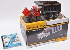 A First Gear 1:25 scale International 'S' Series Dump Truck. Presented in red with a black body.