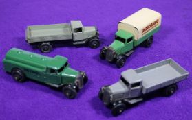 4 Dinky Toys 25 Series Trucks. A Wagon (25a). In grey with black chassis. A Covered Wagon (25b).