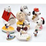 9 Ceramic Peanuts Snoopy Figures. Various types including - Snoopy laying on kennel roof, early