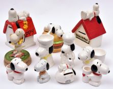 11 Ceramic Peanuts Snoopy figures. Snoopy & Woodstock lying on kennel. Snoopy lying on kennel.