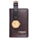 A Longines Quartz watch with quartz movement 18ct gold case and face, black leather strap and date