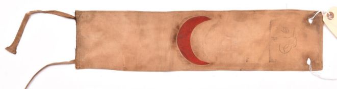 A WWI Turkish armband, red crescent on khaki linen. GC £30-35.