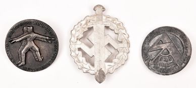 A Third Reich Hitler Youth sports badge in silvered metal, reverse marked “E Schneider Entum DSA