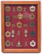 An attractively mounted framed display of Royal Engineers badges: 14 cap badges include Vic and