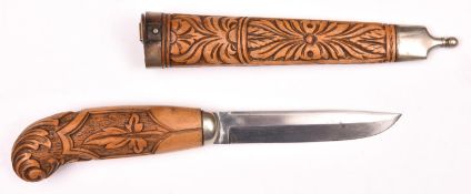 A Scandinavian “filching” knife, blade 3½”, in its sheath, the hilt and sheath of pale wood carved
