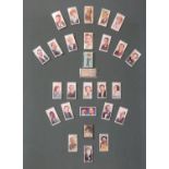 A collection of 27 autographed cigarette cards of film and radio stars including Mae West (signed in