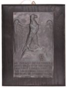 A Third Reich SS plaque, black metal with eagle and runes, inscribed “Die Aufgabe Dieser Front 1st