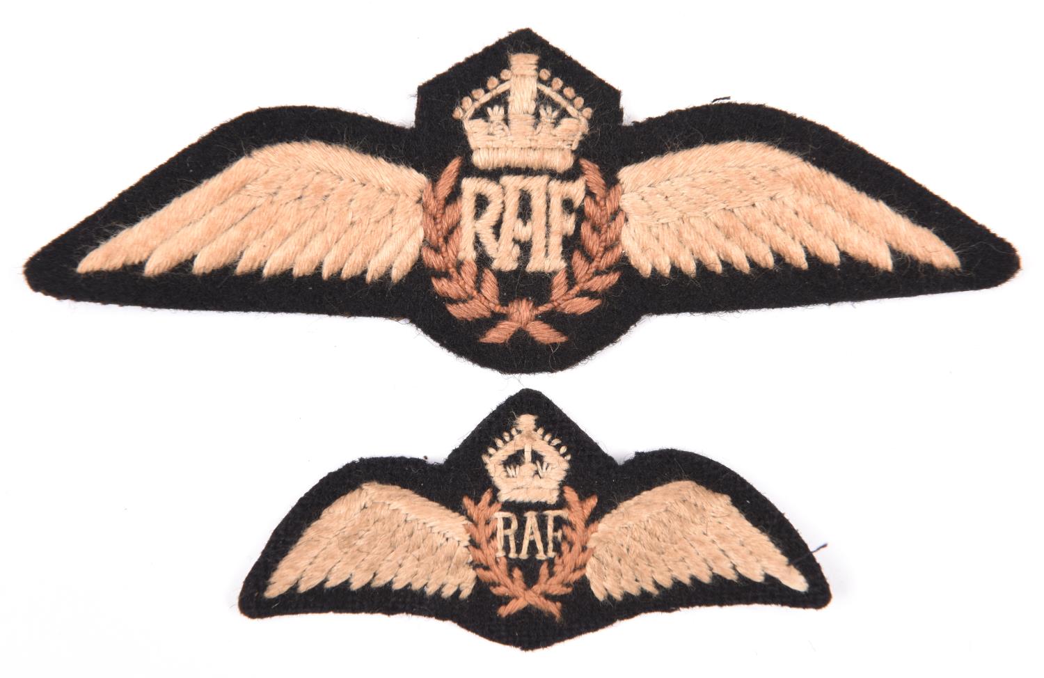 A WWII RAF OR’s embroidered eagle badge, 4½”; another similar 2¾”. GC (2) £30-40.