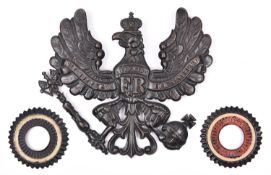 A WWI Prussian grey steel pickelhaube helmet badge, painted black; and a pair of matching