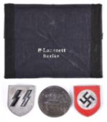 A pair of Third Reich Tropical helmet badges, SS runes and swastika within circle; also a “Munchen