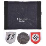 A pair of Third Reich Tropical helmet badges, SS runes and swastika within circle; also a “Munchen