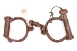 A good pair of Victorian plug lock handcuffs, marked “HIATT BEST WARRENTED WROUGHT 457”, complete