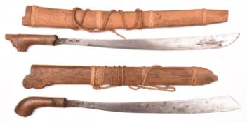 Two Indonesian short swords, klewang, blades 19” and 20”, with plain wooden hilts and sheaths, the