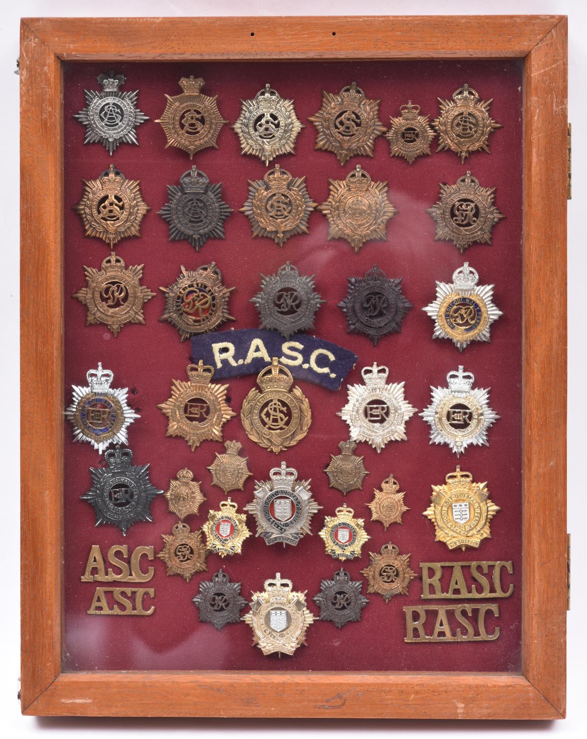 An attractively mounted and framed display of ASC, RASC and Ryl Logistics Corps badges: 23 cap