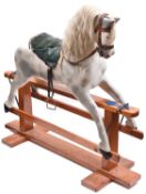 A traditional English children's hand carved wooden rocking horse. This full size horse has been