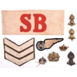 A small quantity of military insignia: red felt on white linen “SB” armband; RAAF Air Gunner’s