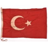 A WWI Turkish flag, 36” x 24”, red cloth with applied white star and crescent, Turkish stamping on