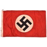 A Third Reich National flag, 85cm x 150cm, applique swastika centre, edge stamped “1939 Berlin”.