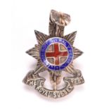 An officer’s cap badge of the Royal Sussex Regiment, of unmarked silver and enamel, with two