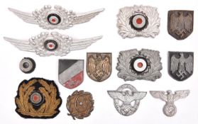 Third Reich insignia: two Luftwaffe NCO’s aluminium cap cockades; two Customs officer’s aluminium