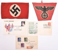 A Third Reich NSDAP member’s printed cloth armband; a small printed triangular flag with black on
