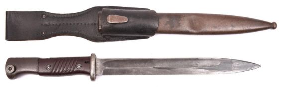 A WWII German K98 bayonet, with maker’s code “43 fn” and bakelite grips, in its scabbard with