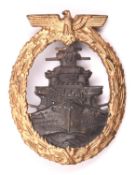 A Third Reich High Seas Fleet badge: gilt eagle and wreath, grey battleship, “SA” in triangle
