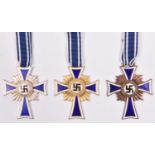 Third Reich Mother’s Cross, in gold, silver and bronze, with ribbons. VGC; together with printed