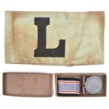 A Third Reich Luftschutz Service medal, in its case of issue; also a green cloth Luftschutz armband.