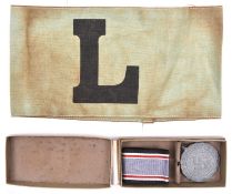 A Third Reich Luftschutz Service medal, in its case of issue; also a green cloth Luftschutz armband.