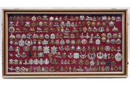 An attractively framed collection of 185 British military cap badges, comprising 38 Cavalry,
