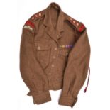 A 1949 pattern khaki battledress blouse, with black on red R.A.O.C. embroidered cloth titles,