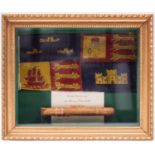 A gilt framed display of a Winston Churchill cigar and a car pennant from Churchill’s car of the