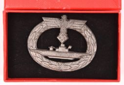 A Third Reich U boat badge, of grey metal with sharp details, the reverse with maker’s initials “R.