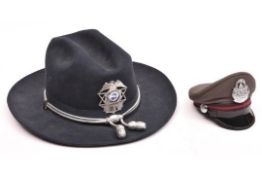 An American 1970s Stratton wide brimmed hard black felt police hat, with silvered cords and “acorns”
