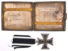 A 1914 Iron Cross 2nd class, with ribbon; also a white metal cigarette case, the lid engraved with a