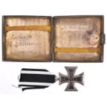 A 1914 Iron Cross 2nd class, with ribbon; also a white metal cigarette case, the lid engraved with a