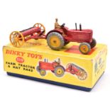 A Dinky Toys Farm Tractor & Hay Rake (310). A Massey-Harris tractor in red with yellow wheels and