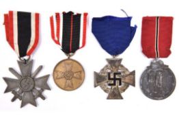 Third Reich medals: War Merit Cross 2nd class with swords, of grey metal, the ring stamped '74'; War