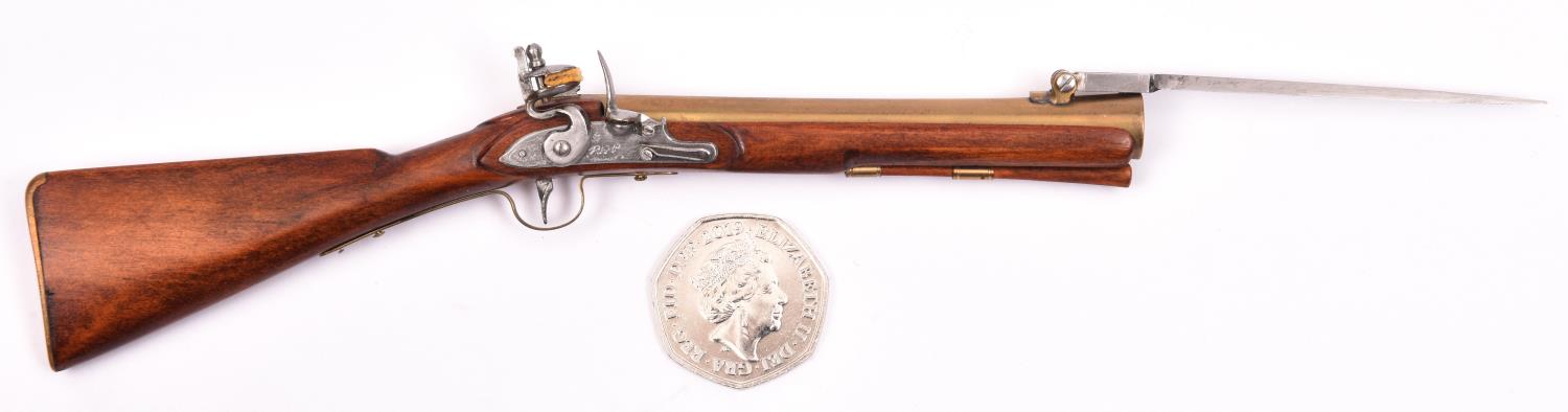 A miniature model of a brass barrelled flintlock blunderbuss with folding bayonet, 6½" overall.