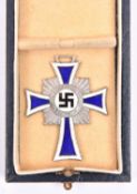 A Third Reich Deutsche Mutter Kreuz, silvered and enamelled, in its case of issue. GC £30-35