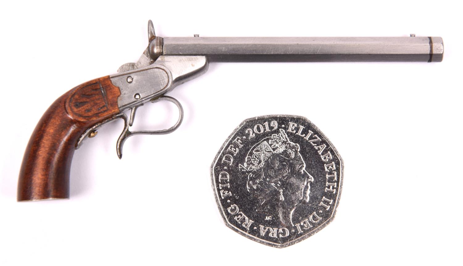 A miniature model of a Belgian rimfire saloon pistol, 3½" overall. GC £25-30