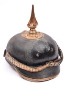 An Imperial German Colonial Gendarmerie NCOs pickelhaube, the leather skull having brass trim and