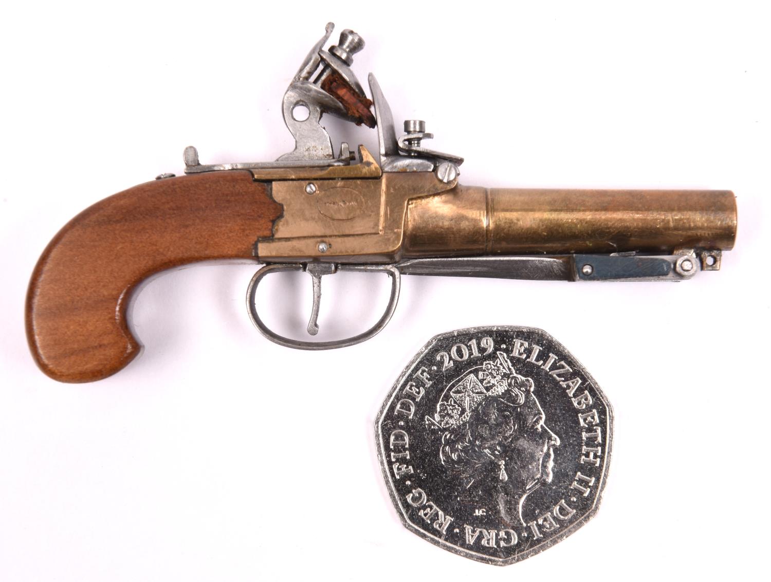 A miniature model of a brass barrelled and brass framed flintlock boxlock pocket pistol with folding