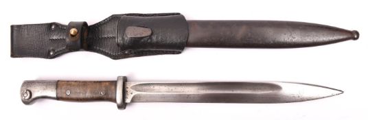 A WWII German K98 bayonet, the blade marked "S/1776" and serial number, with plain wood grips, in