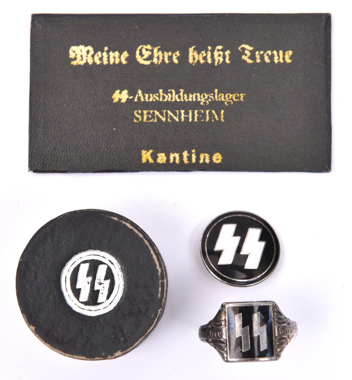 A Third Reich SS enamelled ring, in its case; an SS lapel badge and an SS pocket mirror. GC (3) £