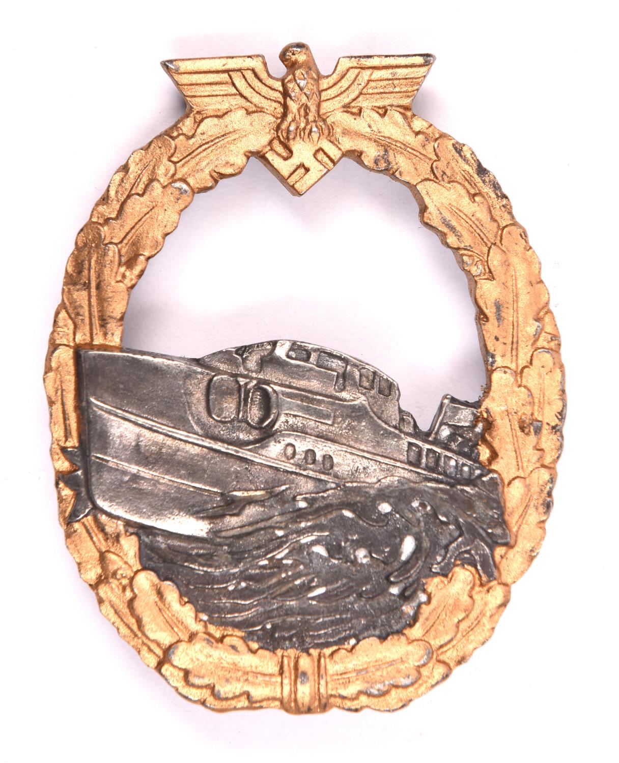 A Third Reich E Boat badge, first pattern, gold washed wreath, silver E Boat, marked on reverse "