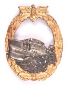 A Third Reich E Boat badge, first pattern, gold washed wreath, silver E Boat, marked on reverse "