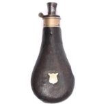 A leather covered powder flask, 7¾" overall, with German silver shield shaped escutcheon and